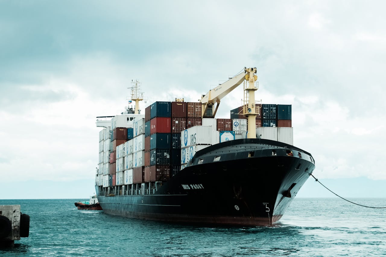 A large cargo ship loaded with shipping containers docked at Davao harbor, Philippines.