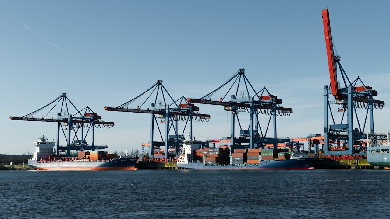 View of container ships and cranes at the bustling Hamburg Port.